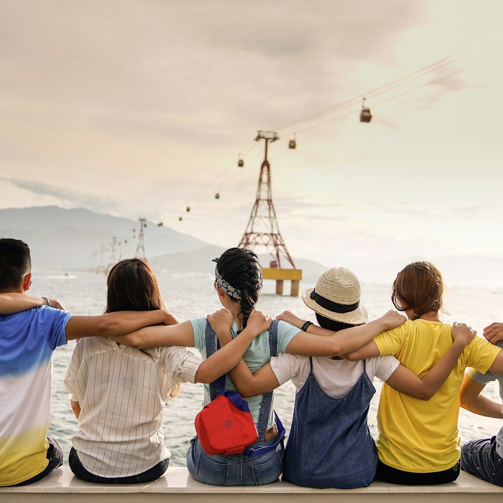 Group of friends sitting together with their arms around one another